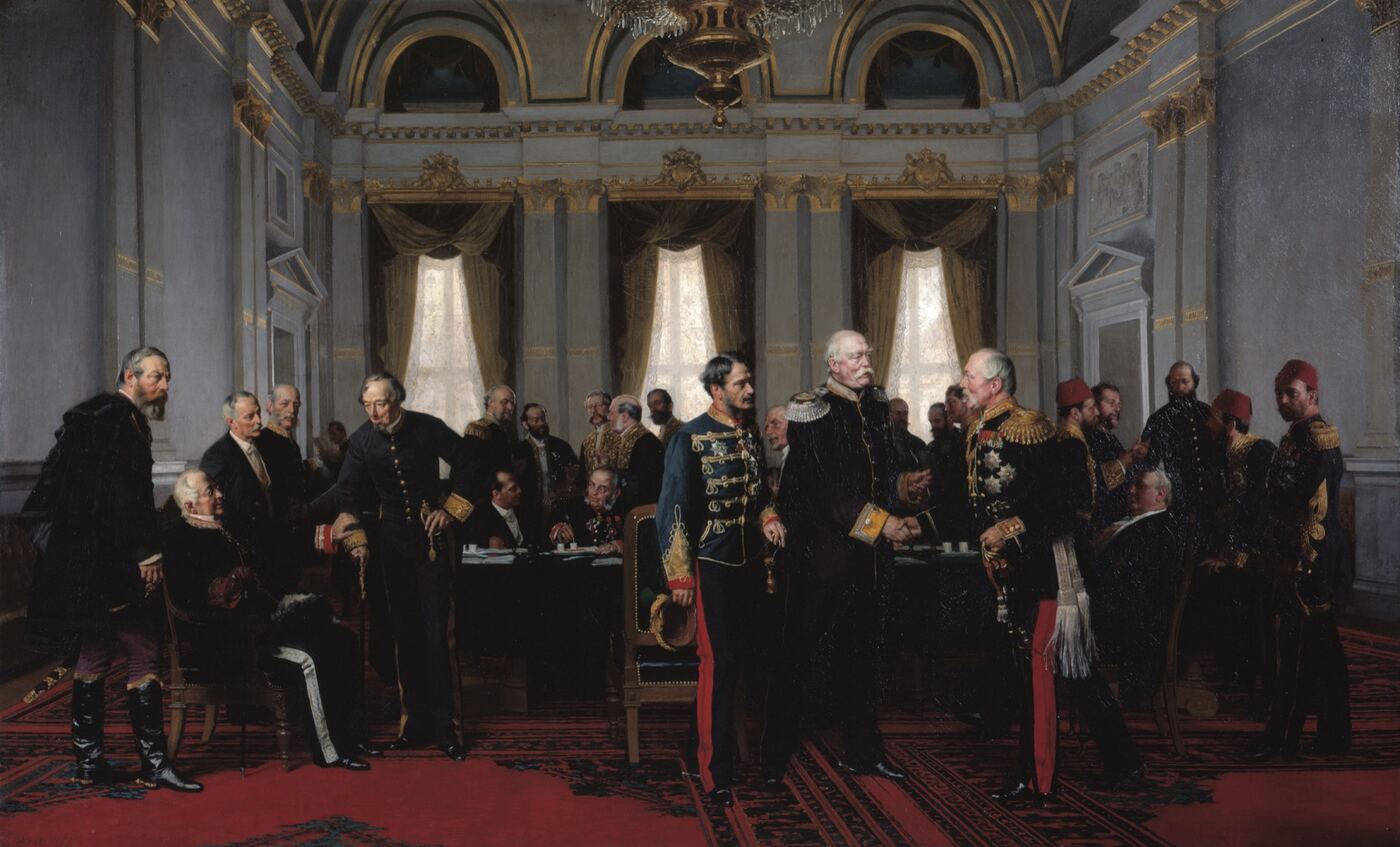 An oil painting of a gilded hall: two dozen men in uniforms, sashes and frock coats around a long table
