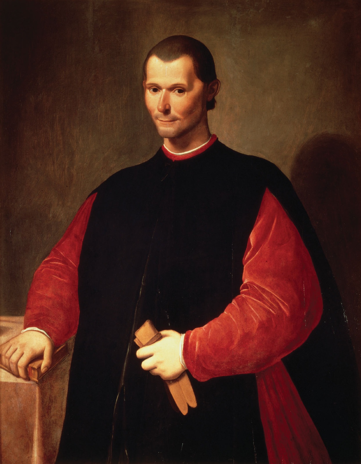 Portrait of Niccolò Machiavelli in black and red robes against a dark ground, faintly smiling