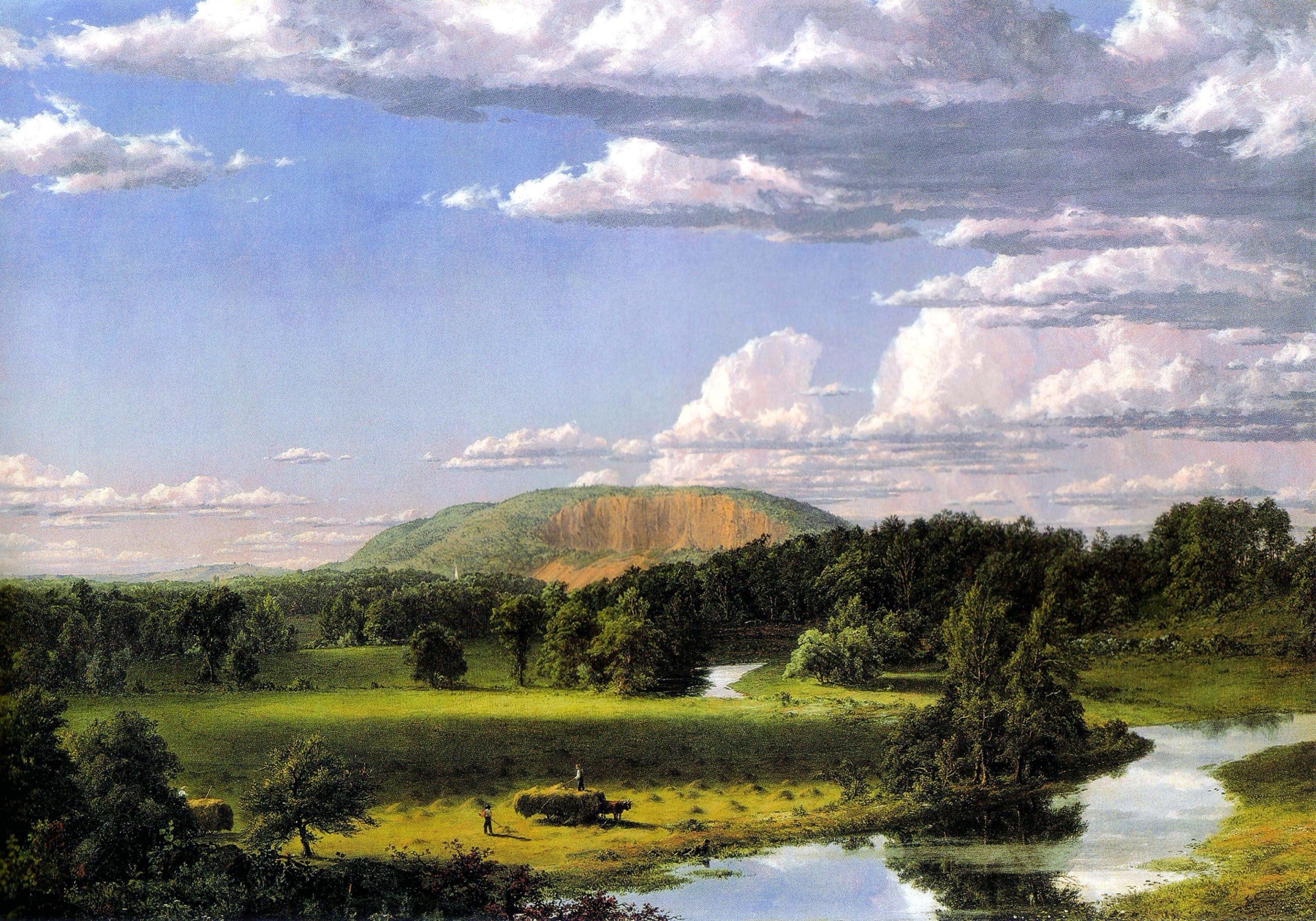 An oil landscape under a tall summer sky: a long wooded ridge with a bare rock face, a white church spire at its foot, a green valley with a winding river, and in the foreground field two small figures loading hay onto a cart
