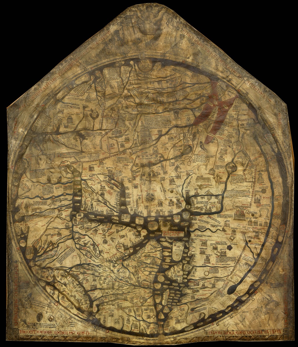 A large medieval world map drawn on vellum, roughly circular inside a pentagonal sheet, crowded with towns, beasts and figures